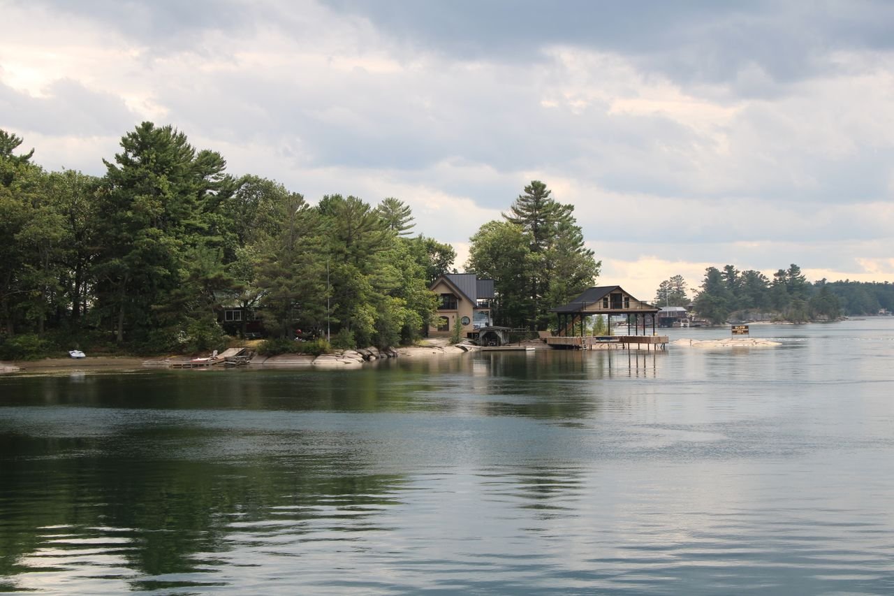 Home Charming lakeside residences surrounded by lush forest, perfect for a tranquil vacation getaway.